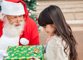 Image showing Girl Taking Christmas Gift From Santa Claus