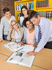 Image showing Teachers And Students Discussing Over Book In Library