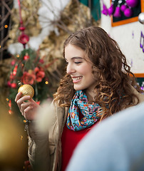 Image showing Woman Looking At Golden Bauble In Store