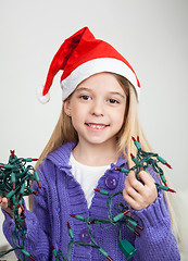 Image showing Girl In Santa Hat Holding Fairy Lights