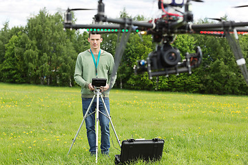 Image showing Technician Flying UAV Helicopter