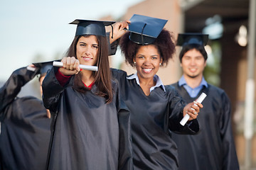 Image showing Female Students Showing Certificates On College Campus