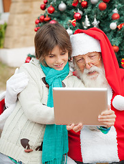 Image showing Santa Claus Using Digital Tablet With Boy