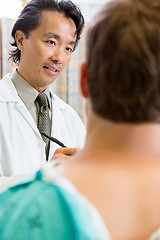 Image showing Doctor Looking At Patient While Discussing Report