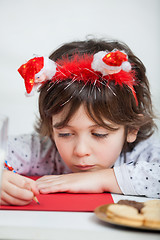 Image showing Boy Wearing Santa Headband Writing Letter To Santa Claus