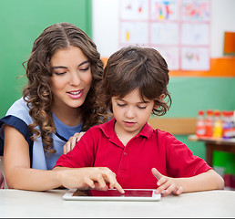 Image showing Teacher Teaching Students To Use Digital Tablet