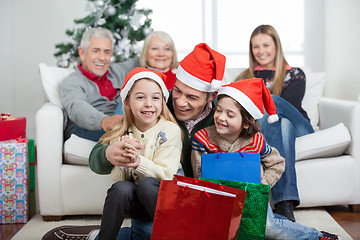 Image showing Children And Father With Gifts During Christmas