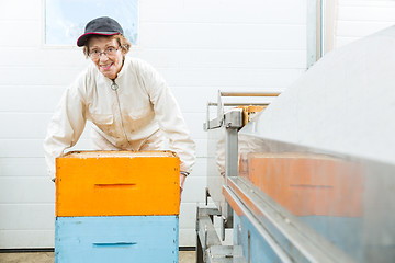 Image showing Portrait Of Beekeeper With Honeycomb Crates At Factory