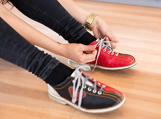 Image showing Woman Tying Shoe Lace in Club