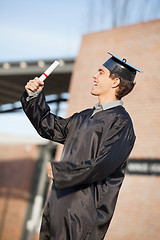 Image showing Man Holding Diploma On Graduation Day At Campus