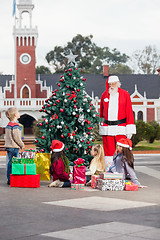 Image showing Santa Claus And Children By Decorated Christmas Tree