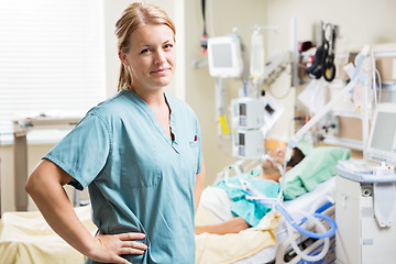 Image showing Confident Nurse With Patient Resting In Background