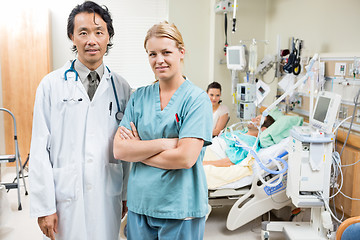 Image showing Nurse And Doctor With Patient Resting In Background