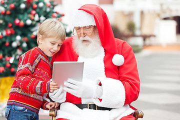 Image showing Boy And Santa Claus Using Digital Tablet