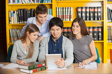 Image showing Students With Digital Tablet Studying Together In College Librar