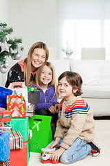 Image showing Mother And Children With Christmas Gifts