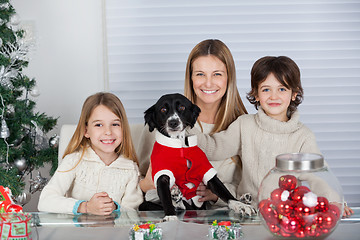 Image showing Happy Family With Pet Dog During Christmas