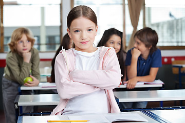 Image showing Schoolgirl Standing Arms Crossed In Classroom