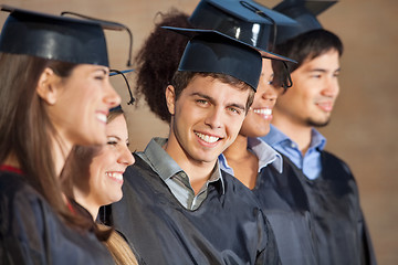 Image showing Happy Man Standing With Students On Graduation Day In College