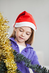 Image showing Girl Looking At Tinsels During Christmas