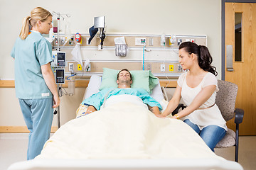 Image showing Woman Holding Patient's Hand In Hospital Room