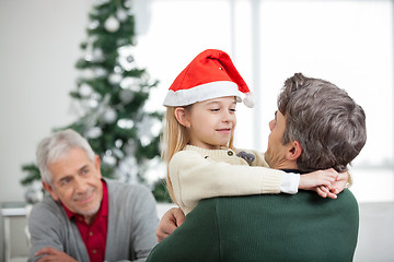 Image showing Girl Embracing Father During Christmas