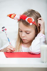 Image showing Girl Wearing Headband Writing Letter To Santa Claus