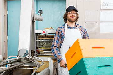 Image showing Beekeeper With Trolley Of Stacked Honeycomb Crates