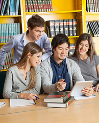 Image showing Students With Digital Tablet Discussing In College Library