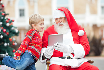 Image showing Santa Claus Showing Digital Tablet To Boy