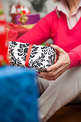 Image showing Senior Woman Holding Christmas Gift