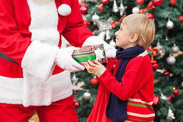 Image showing Santa Claus Giving Gift To Boy