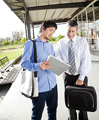 Image showing Teacher And Student Discussing Over Book On Campus