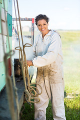 Image showing Happy Beekeeper Preparing Smoker On Truck