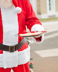 Image showing Santa Claus Holding Plate With Cookies