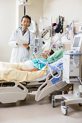 Image showing Doctor With Digital Tablet Examining Patient's Report
