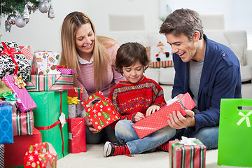 Image showing Parents Giving Christmas Present To Son