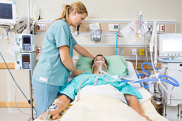 Image showing Nurse Adjusting Patient's Pillow