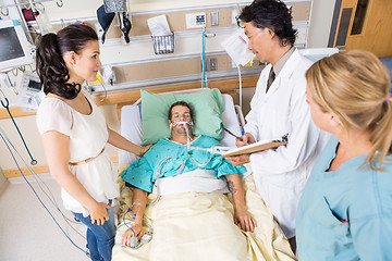 Image showing Woman Looking At Doctor Examining Patient