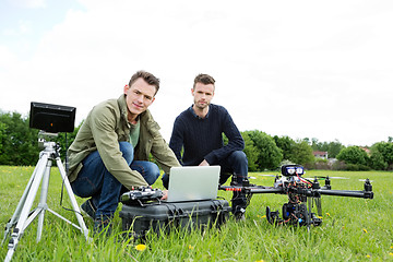 Image showing Engineers Using Laptop By UAV Helicopter