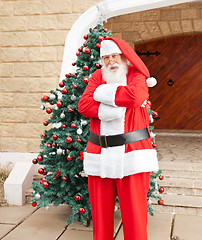 Image showing Santa Claus Standing Arms Crossed Outside House