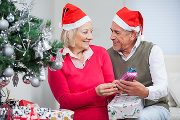 Image showing Couple With Christmas Gifts Looking At Each Other