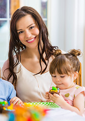 Image showing Mother With Birthday Girl Eating Cake