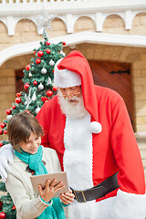 Image showing Santa Claus And Boy Using Digital Tablet