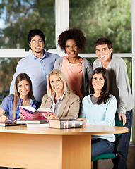 Image showing University Students And Professor With Books In Classroom