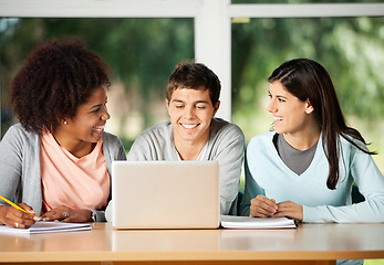 Image showing Happy Friends With Laptop Sitting In Classroom