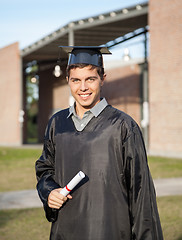 Image showing Graduate Student Holding Diploma On Graduation Day At Campus