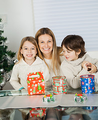 Image showing Loving Mother And Siblings With Christmas Presents