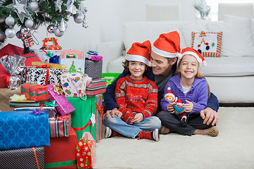 Image showing Siblings With Father At Home During Christmas