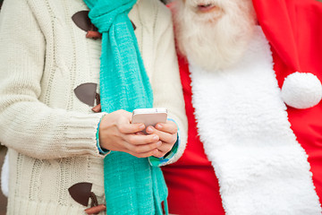 Image showing Santa Claus With Boy Using Smartphone